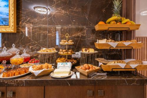 a buffet with many different types of bread and pastries at FLOARA DI MUNTE Forest Luxury Suites in Metsovo