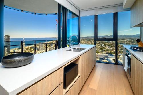 a kitchen with a counter with a view of the city at Cloud Nine Retreat - Luxe 44th Fl Apartment in Gold Coast