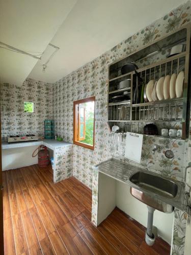 a kitchen with a sink and a counter top at Mountaintop Guest House in Bhurtuk