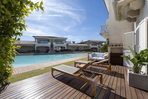 a backyard with a swimming pool and a house at Sardinia Gold Luxury Apartment in Palau