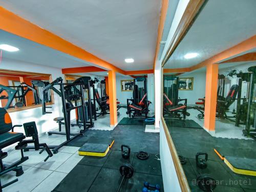 a gym with treadmills and machines in a room at Hotel e Restaurante Rio Mar in Valença