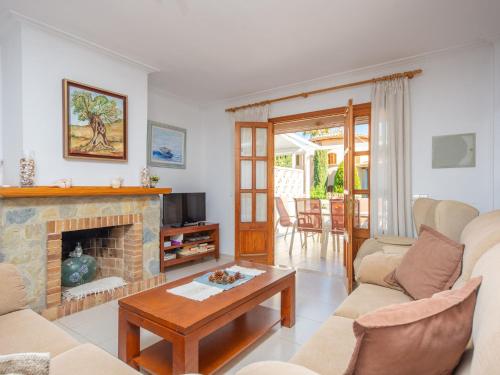 a living room with a fireplace and a tv at North House - House In Platja De Muro Free Wifi in Playa de Muro
