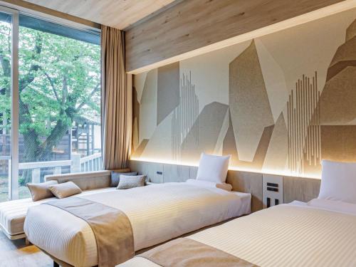 Ένα ή περισσότερα κρεβάτια σε δωμάτιο στο Kamenoi Hotel Tsukubasan