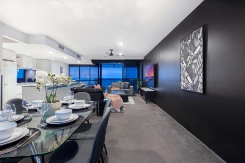 a dining room and living room with a table and chairs at Circle on Cavill - Self Contained & Privately Managed - Wow Stay in Gold Coast