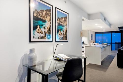 a glass table and a chair in a room at Circle on Cavill - Self Contained & Privately Managed - Wow Stay in Gold Coast
