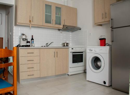 a kitchen with a washing machine and a washer at Eleni's Home 