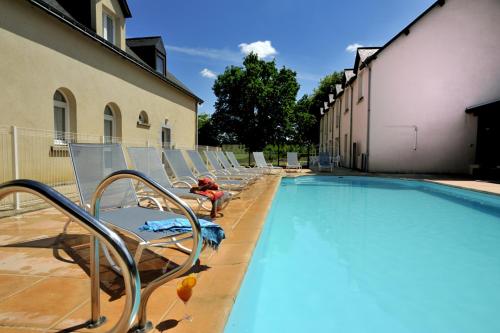 a row of chairs and a swimming pool at Logis Hôtel Restaurant Relais Du Gué De Selle in Évron