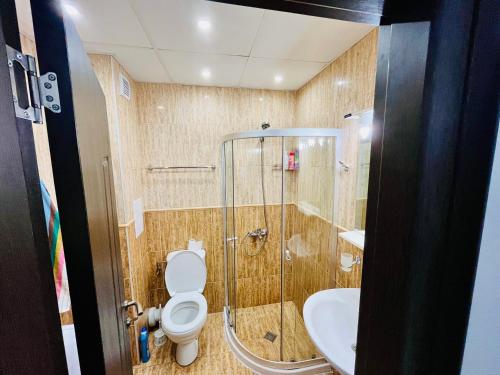 a bathroom with a shower and a toilet and a sink at Studio Pomorie Tuthon in Pomorie