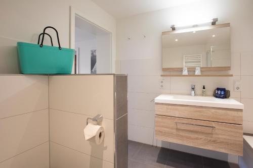 a bathroom with a sink and a mirror at Luv in Juist