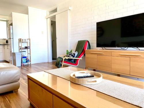 a living room with a large flat screen tv at Location Location Vacation in Fremantle