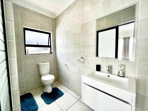 a bathroom with a toilet and a sink at TK’s Penthouse - The Blyde in Pretoria