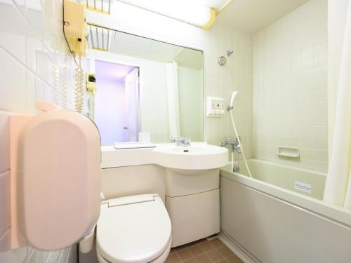 a bathroom with a toilet and a sink and a mirror at Hotel Green Park Suzuka in Suzuka