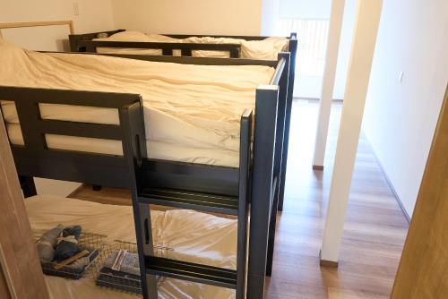two bunk beds in a room with a glass floor at 尾道stay源 -MINAMOTO- in Kaneyoshi