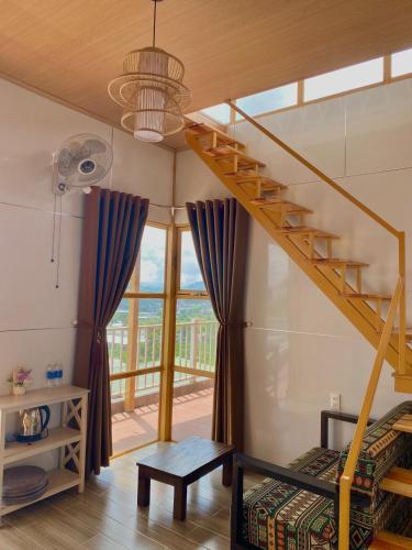 a living room with a staircase in a house at Dứa Homestay in Bao Loc