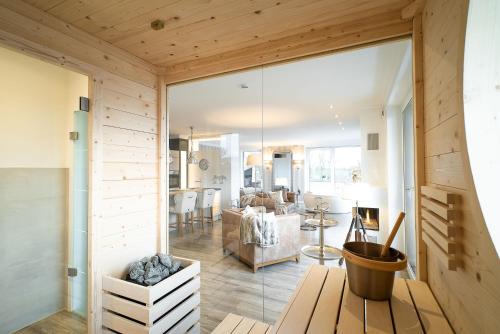 a living room and dining room with a large sliding glass door at Luxus Spa Penthouse Royal in Göhren-Lebbin