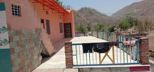 a balcony of a house with clothes hanging on a fence at Maruti Paradise Resort in Udaipur