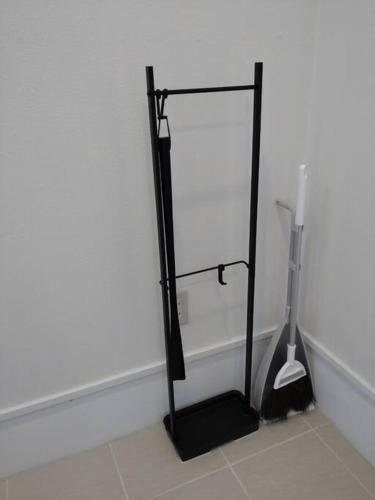 a black stand in a room with a white wall at NEXUS Ishinomakiokaidou in Ishinomaki