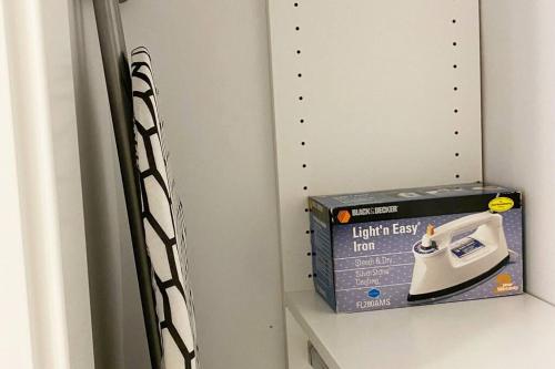 a room with a lightest iron and a box at Two Bedroom Suite Burnaby Metrotown in Burnaby