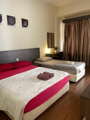 a hotel room with two beds and a room with at Junikastay BLagoon Melaka in Melaka