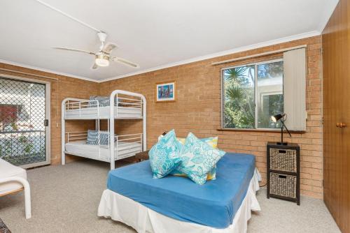 a bedroom with a bed and a bunk bed at 1 In Bruns in Brunswick Heads