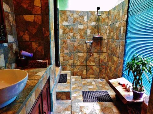 a bathroom with a sink and a shower at Merta House Jasan Village in Tegalalang