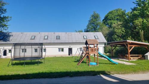 a playground with a slide and a swing at Amálkin Dvor in Podbrezová