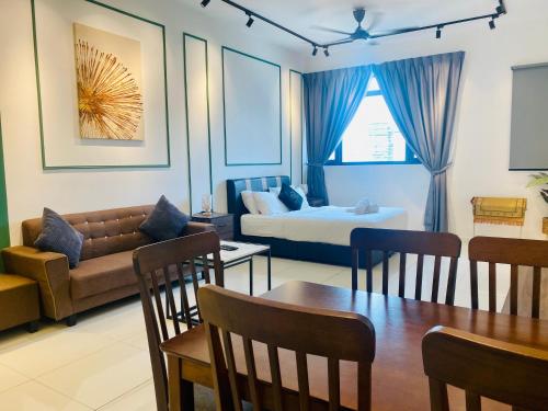 a living room with a couch and a table at Chambers Residences ZFJ World in Kuala Lumpur