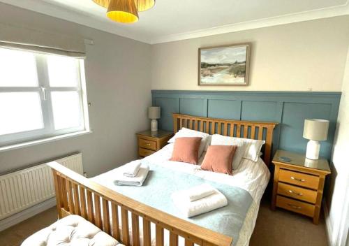 a bedroom with a bed with two towels on it at Beach Mews in Torquay