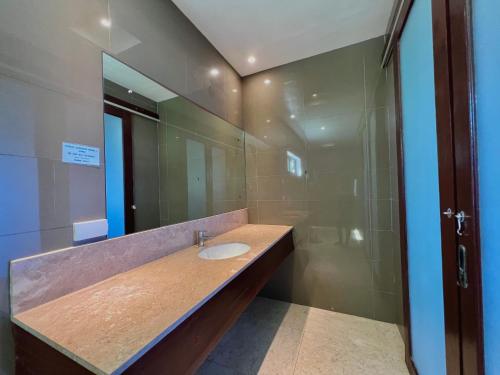 a bathroom with a sink and a shower at Balay Pacifico in Sarog