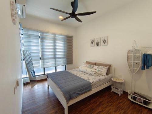 a bedroom with a bed with a ceiling fan at K-Avenue JANNATH269 HOMESTAY KKIA KK in Donggongon