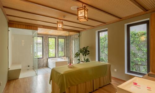 a large bathroom with a tub and a shower at The Saga Hotel Hoi An in Hoi An