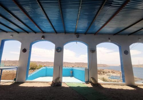 a view from the inside of a building with four windows at Asilah kato nubian guest house in Aswan