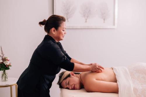 a woman is petting a pregnant woman at The Ritz-Carlton, Half Moon Bay in Half Moon Bay