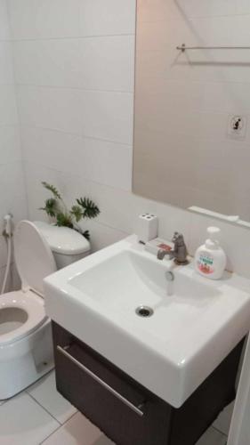 a white bathroom with a sink and a toilet at Otto Stay BKK airport 10 mins, Near Malls & Night Market in Ban Khlong Lat Bua Khao