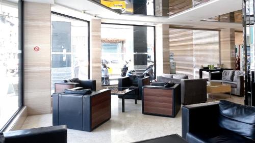 a lobby with couches and chairs in a room at Delton Hotel in Kaohsiung