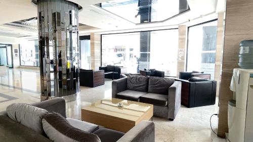 a lobby with couches and tables in a building at Delton Hotel in Kaohsiung