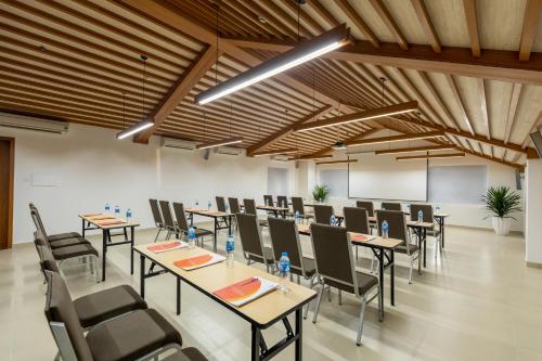 a large room with tables and chairs in it at The Saga Hotel Hoi An in Hoi An