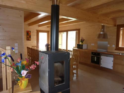 a living room with a stove in a kitchen at Chalet Bellevue in Les Orres
