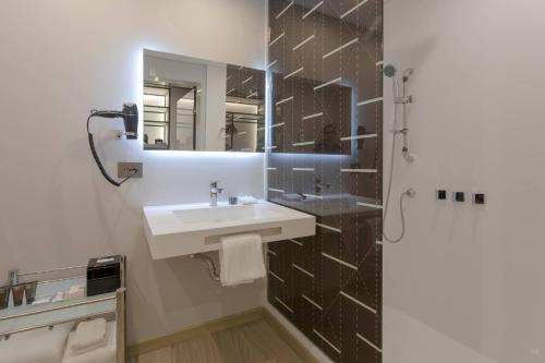a bathroom with a sink and a mirror at AC Hotel By Marriott Santa Marta in Santa Marta