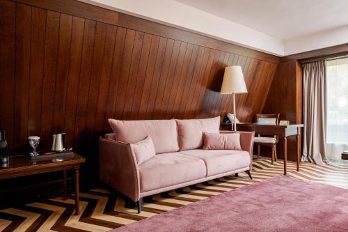 a living room with a couch and a desk at Hotel International in Sinaia