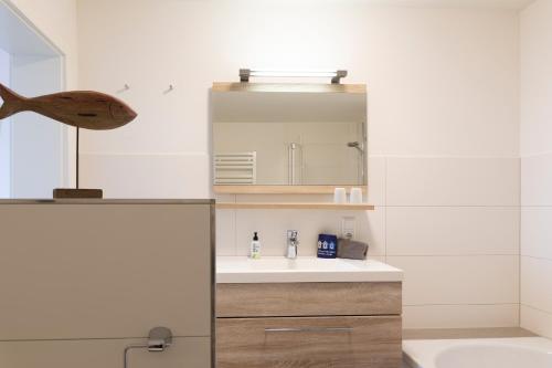 a bathroom with a sink and a mirror at Lee in Juist