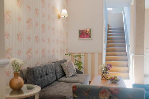 a living room with a couch and a staircase at Karma Chalets in Gurgaon