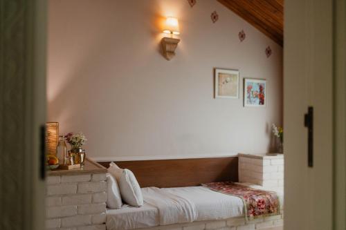 a bedroom with a bed in a brick wall at Karma Chalets in Gurgaon