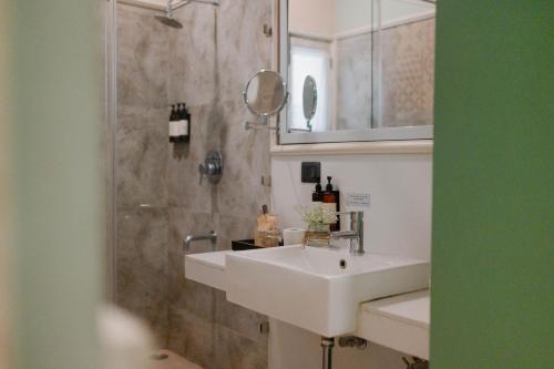 a bathroom with a sink and a shower at Karma Chalets in Gurgaon