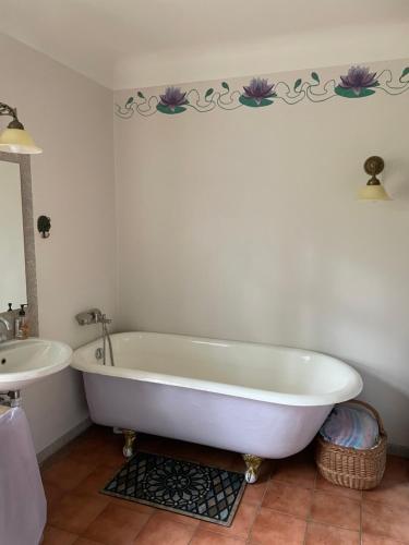 a bathroom with a white tub and a sink at Mazelejas muižiņa in Vircava