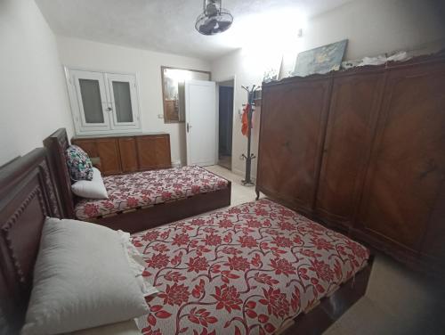 a bedroom with two beds and a couch in it at Beachfront Villa 3bedrooms+3bathrooms in El Alamein