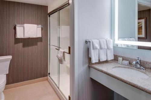 a bathroom with a sink and a shower at Courtyard by Marriott Portsmouth in Portsmouth