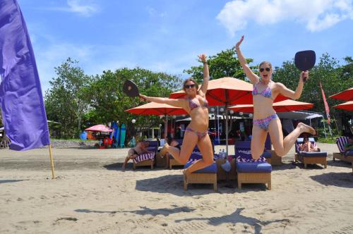two women in bathing suits on a beach at Horison Ultima Seminyak Bali - CHSE Certified in Seminyak
