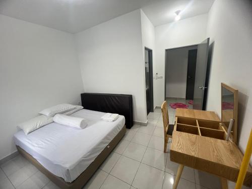 a bedroom with a bed and a table and a mirror at 75 Suite (Tower B) in Papar