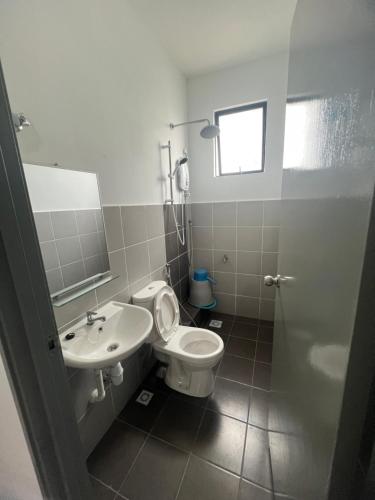 a bathroom with a toilet and a sink at 75 Suite (Tower B) in Papar